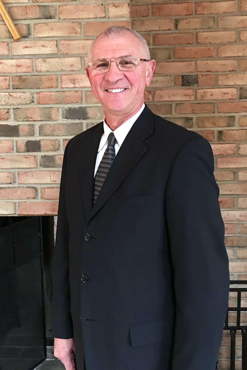 Dr. Wiesel smiling wearing a suit and tie